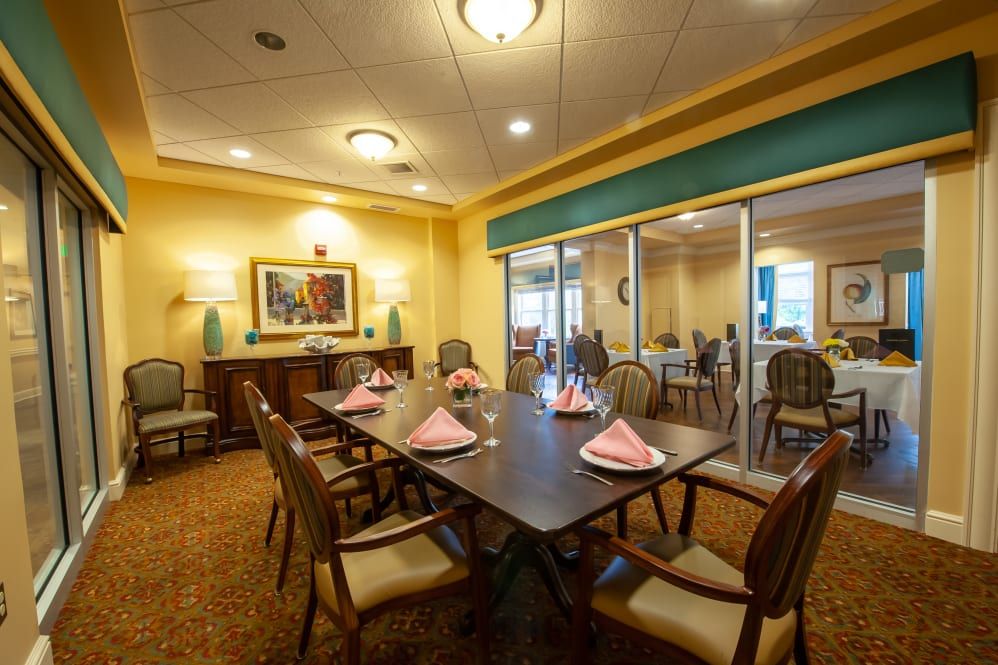 A well-decorated dining room with a large table set for a meal.