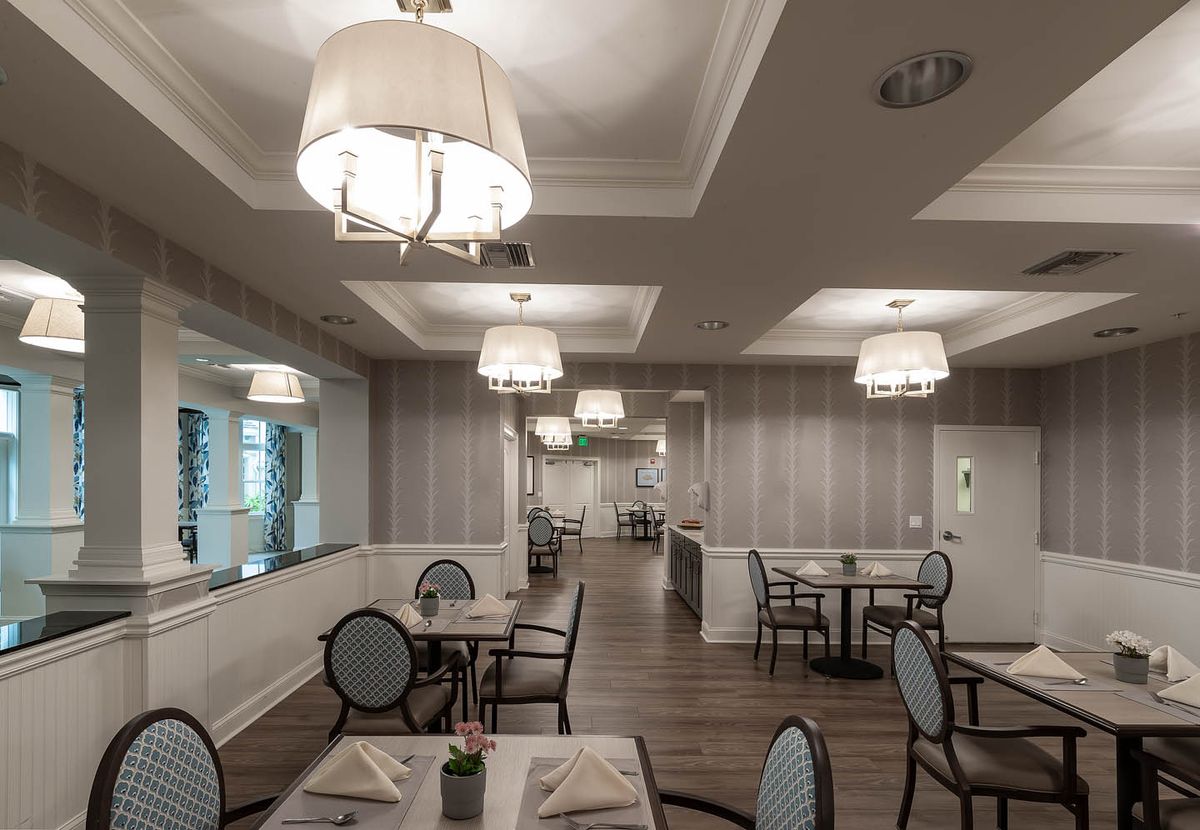 An elegant dining area with neatly arranged tables and stylish lighting.