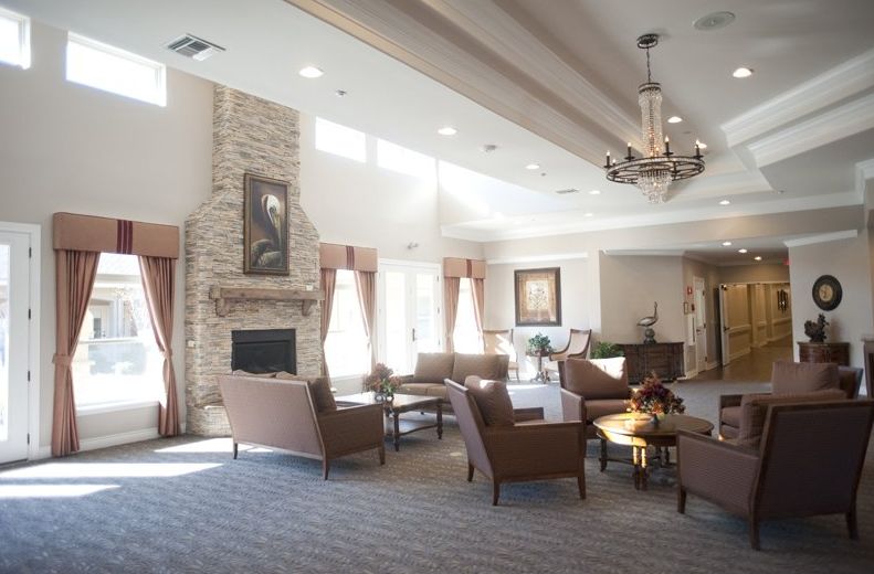 A spacious living room with a fireplace, comfortable seating, and elegant decor.