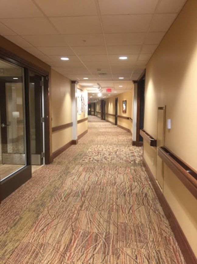 A well-lit, carpeted hallway with modern interior design.