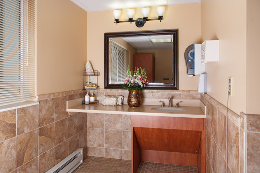 A well-appointed bathroom featuring a stylish vanity, modern sink, and decorative flowers.