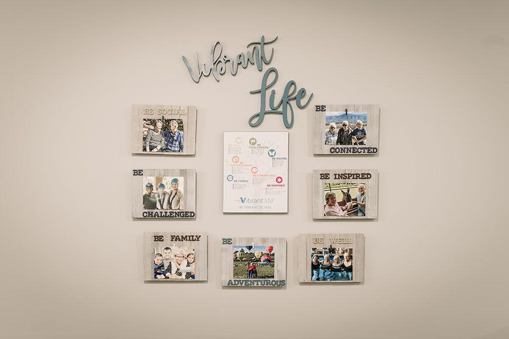 A beautifully arranged family photo collage with a motivational quote on the wall.