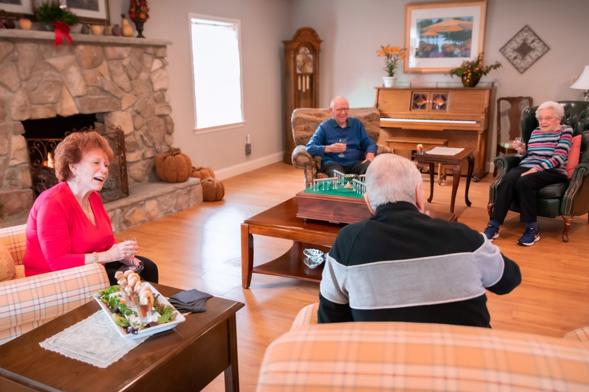 A group of seniors enjoying a conversation in a cozy living room.