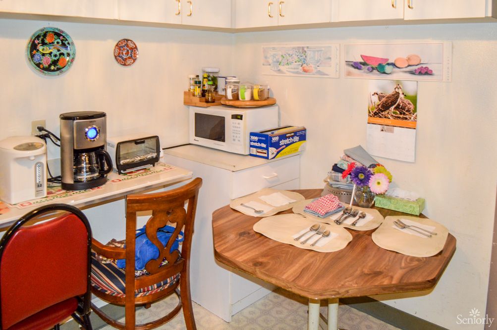 Cozy kitchen corner with a small dining table set and appliances.