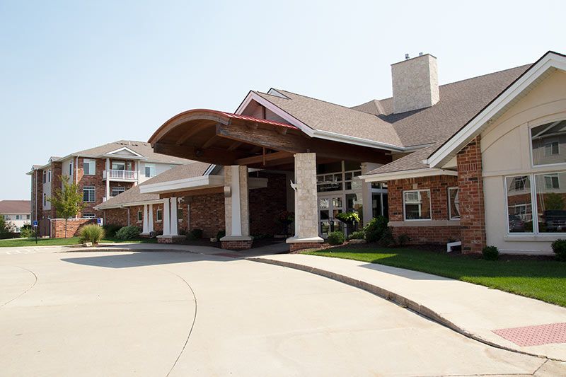 A welcoming entrance to a residential building with a covered driveway.