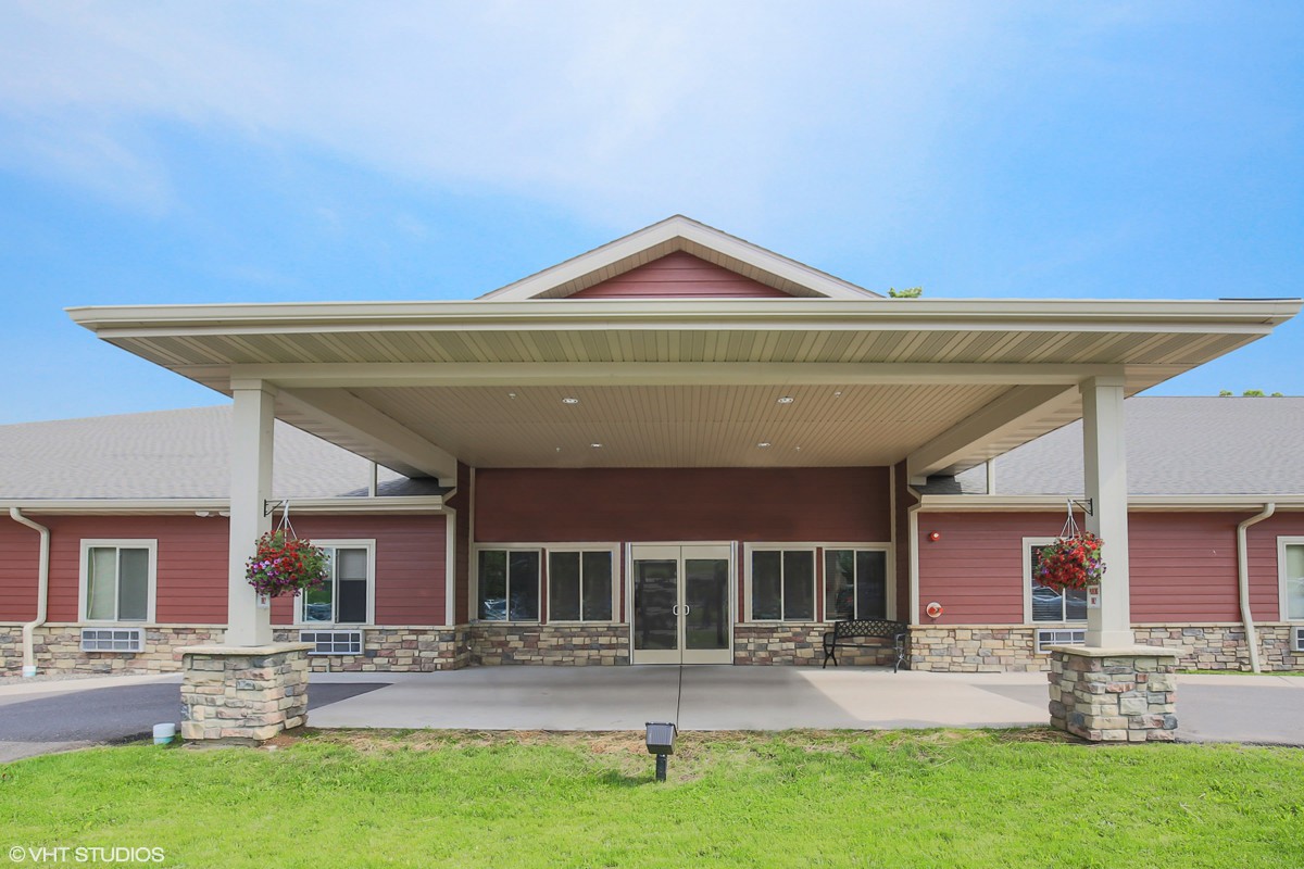 A modern building with a prominent entrance and well-maintained landscaping.