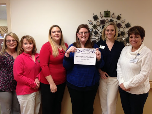 A team celebration with a certificate of achievement.