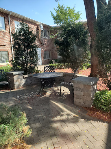 A peaceful outdoor seating area surrounded by greenery, perfect for relaxation.
