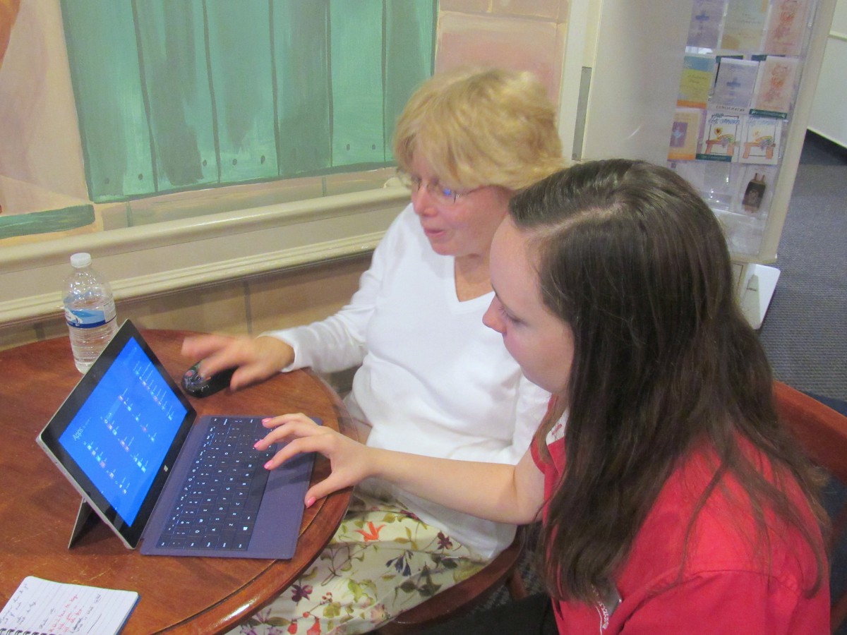 Two people working together on a laptop.