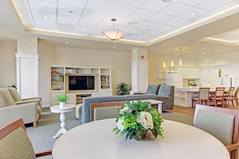 A modern living room with comfortable seating, a large TV unit, and stylish decor.