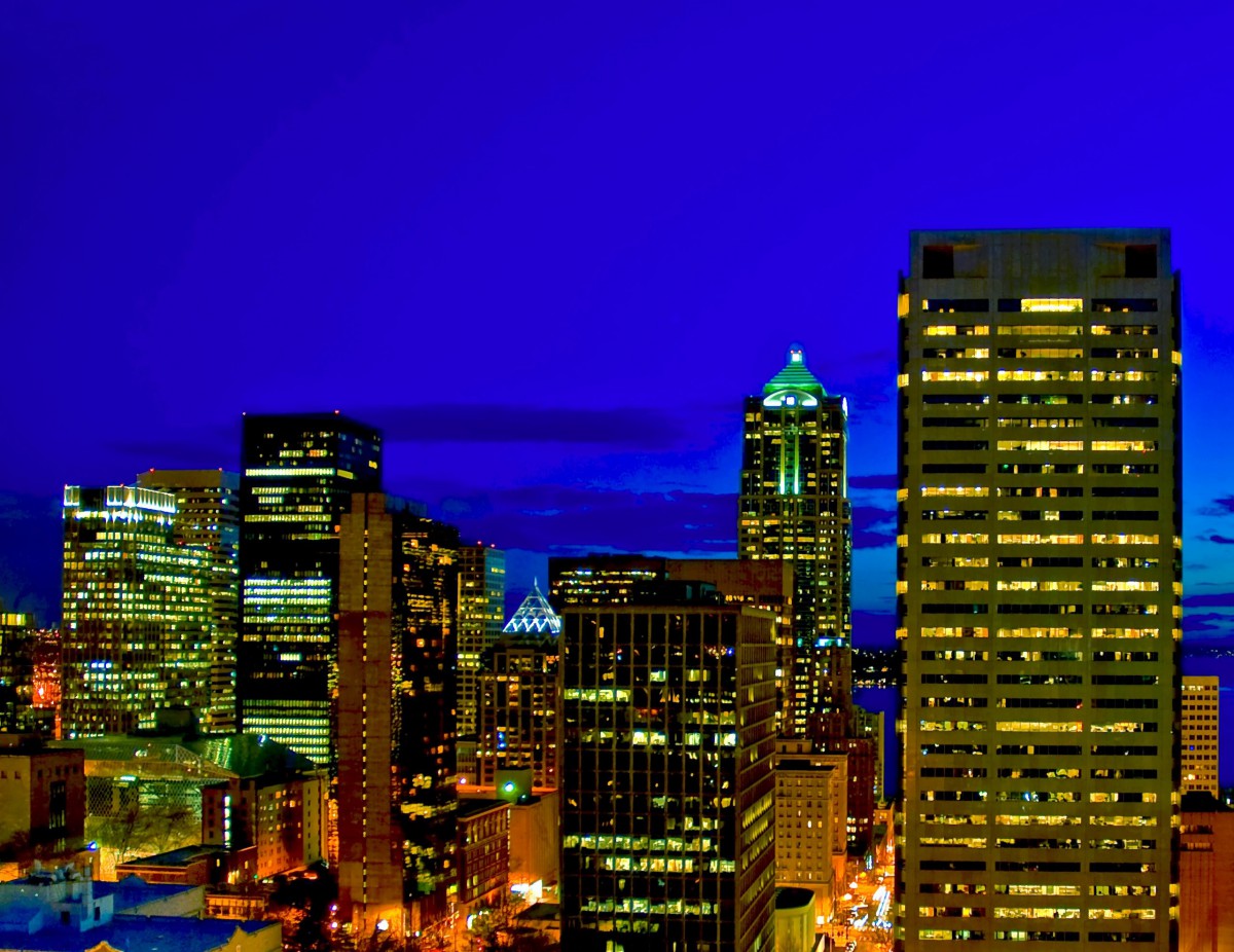 A vibrant city skyline illuminated at night.
