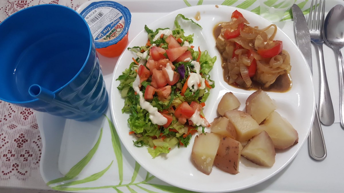 A healthy meal tray with salad, cooked vegetables, and potatoes.