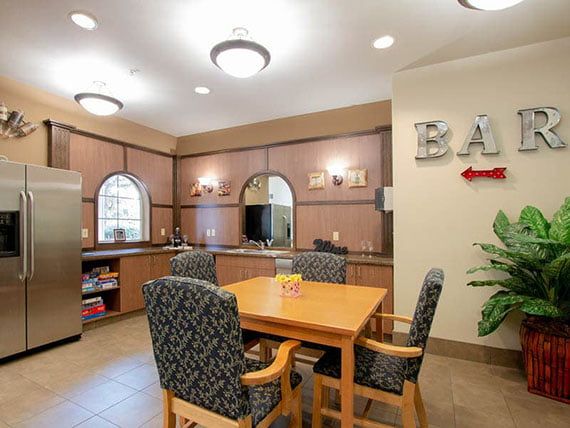 A cozy dining area with wooden furniture and stylish lighting.
