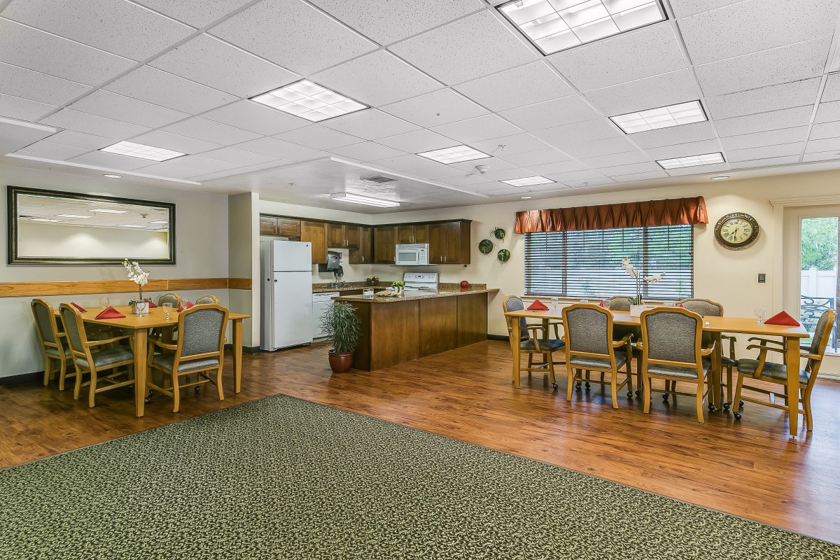 A cozy kitchen and dining area featuring wooden furniture and modern appliances.