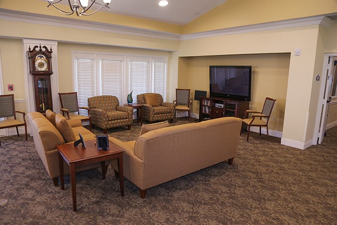 A cozy living room with comfortable seating and a large television.