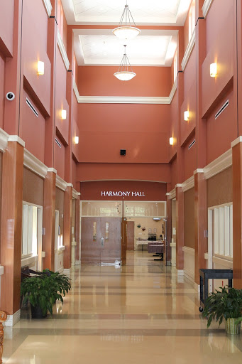 A well-lit hallway with a modern design and warm-colored walls.