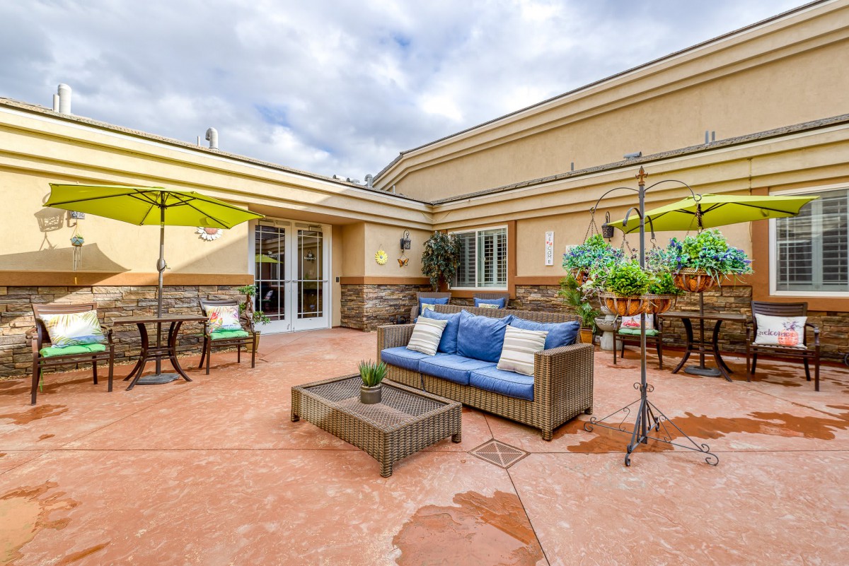 A cozy outdoor patio setup with seating and umbrellas.