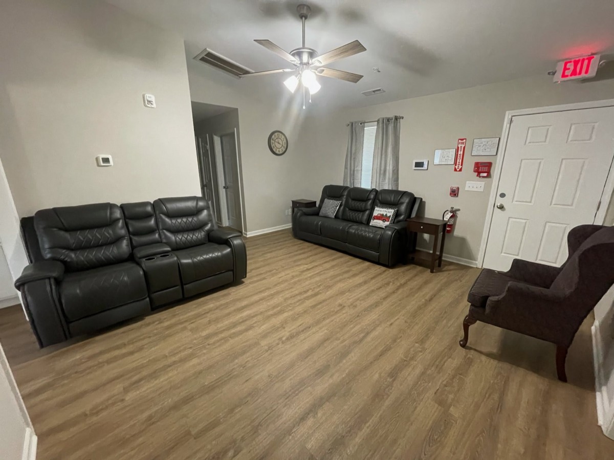 A spacious living room with comfortable seating and wood flooring.