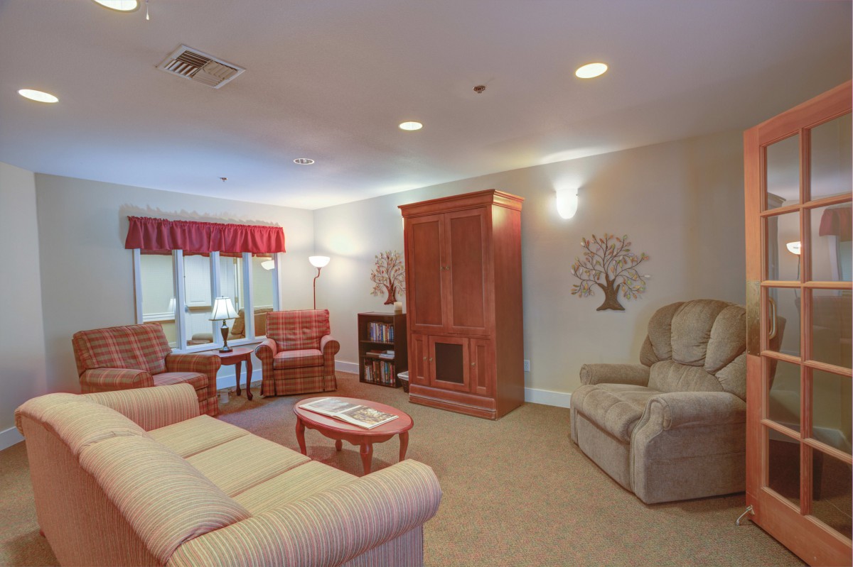A cozy living room with comfortable seating, wooden furniture, and soft lighting.
