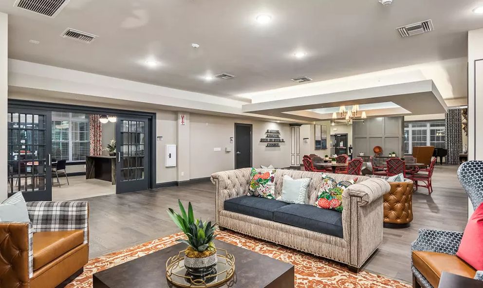 A modern and spacious living room with stylish furniture and elegant decor.