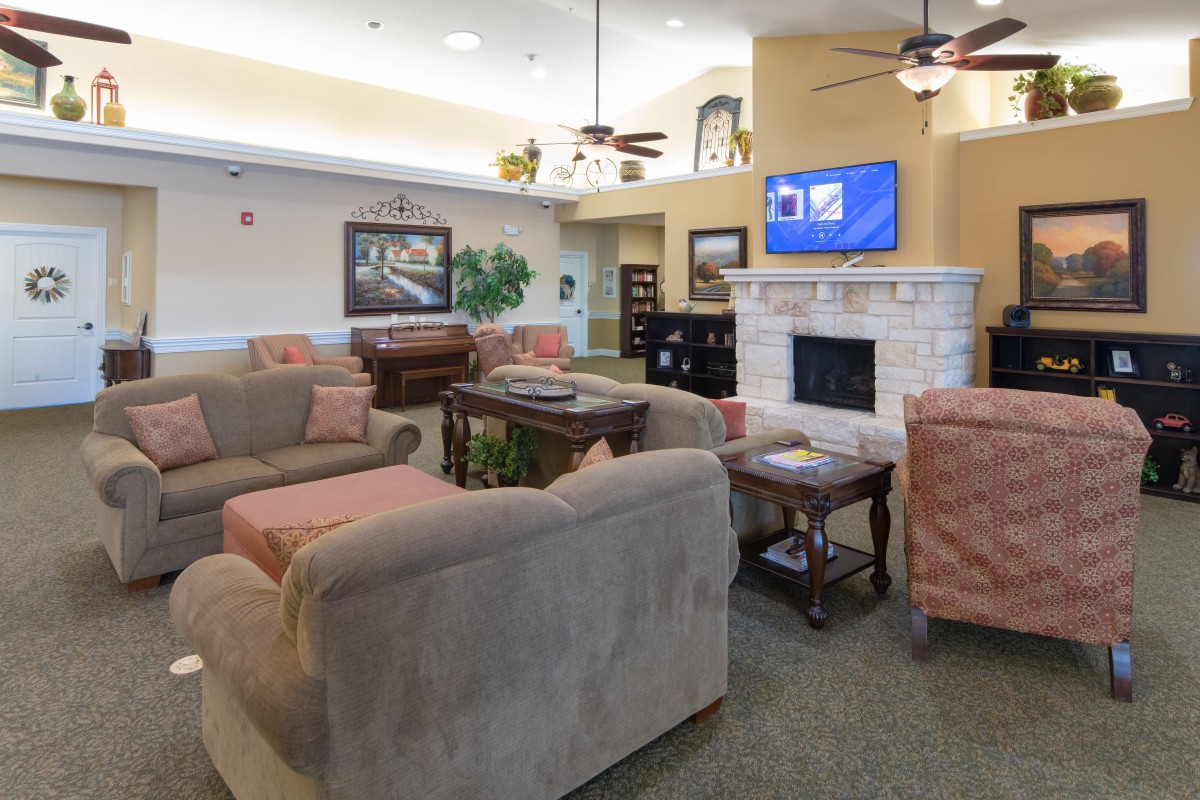 A cozy living room with comfortable seating, a fireplace, and a television.