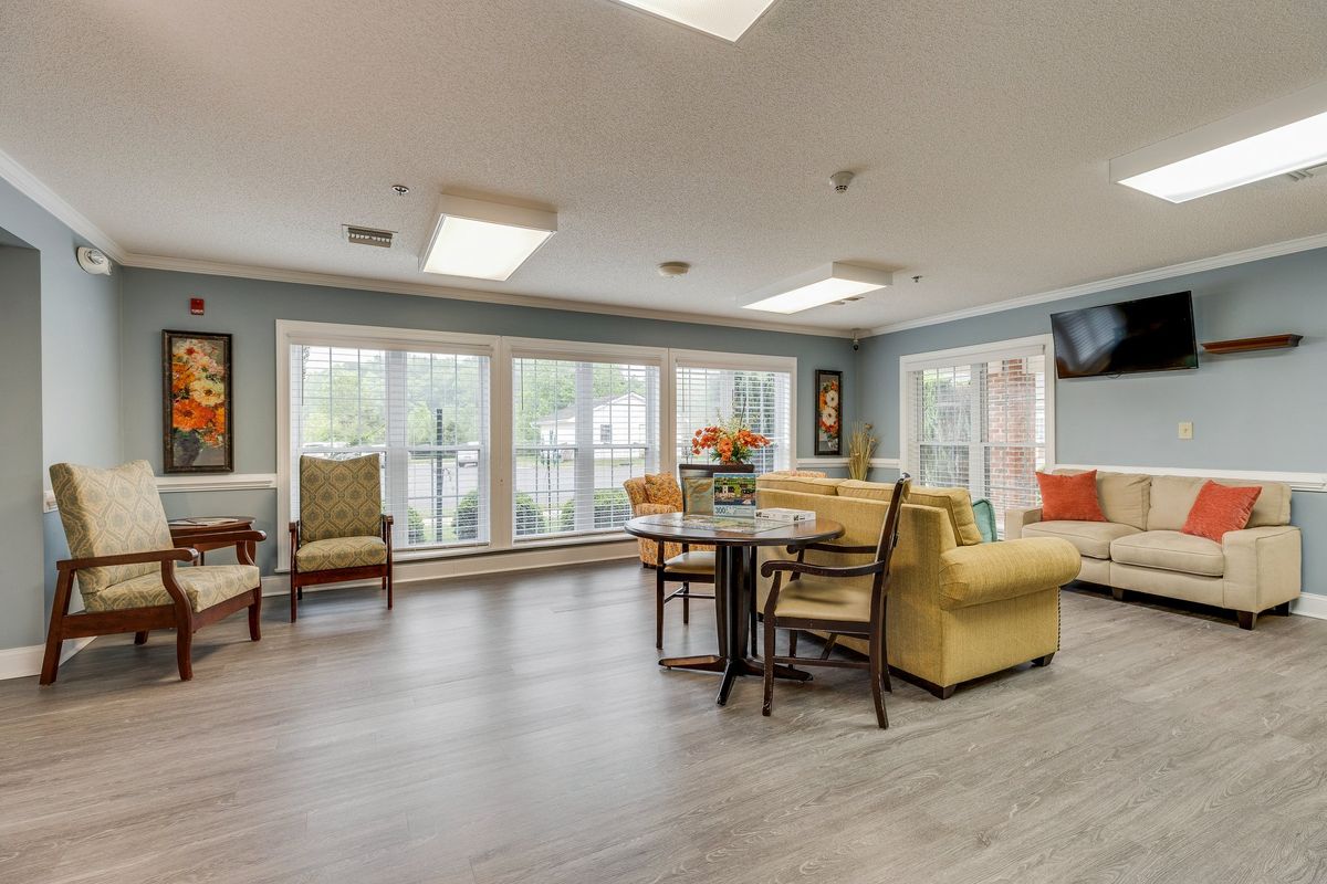 A modern living room with comfortable seating and large windows.