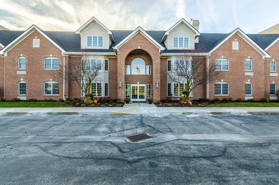 A two-story brick apartment building with symmetrically placed windows and a central entrance.