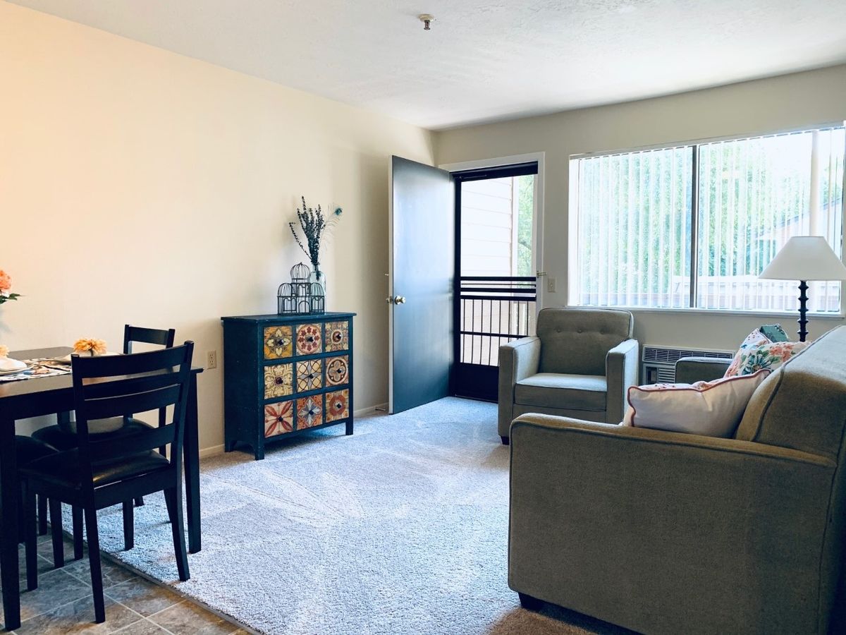 A bright and cozy living room with modern furniture and large windows.