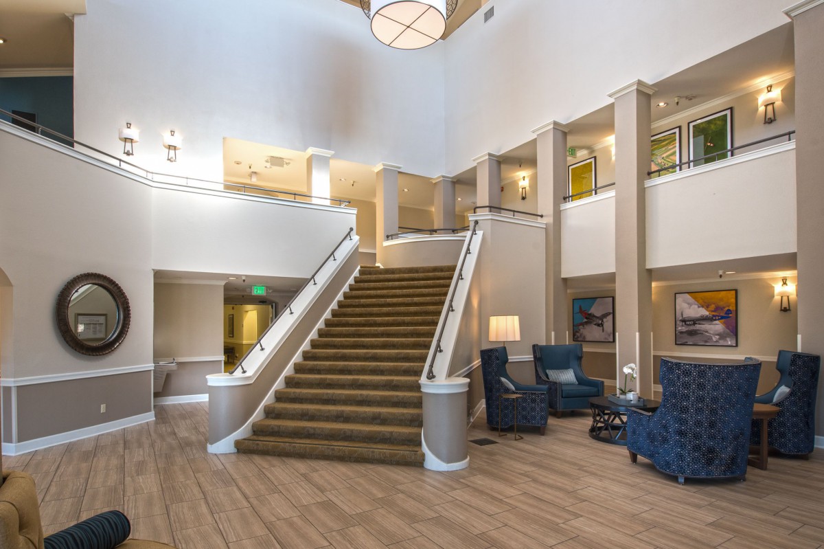 Spacious lobby with central staircase and seating area.