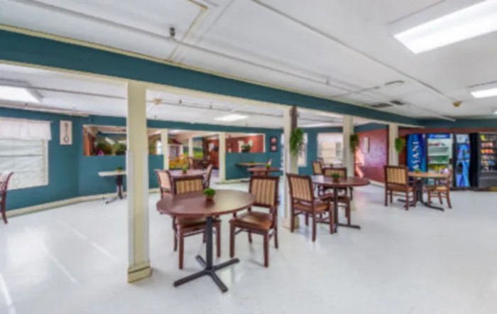 An empty dining area with tables and chairs arranged neatly.