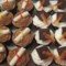 A close-up view of chocolate cupcakes topped with white icing.