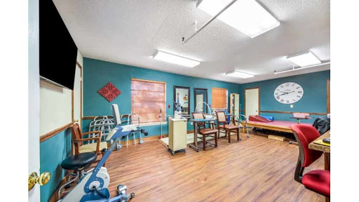 A bright and inviting therapy room equipped with exercise tools and a comfortable seating area.