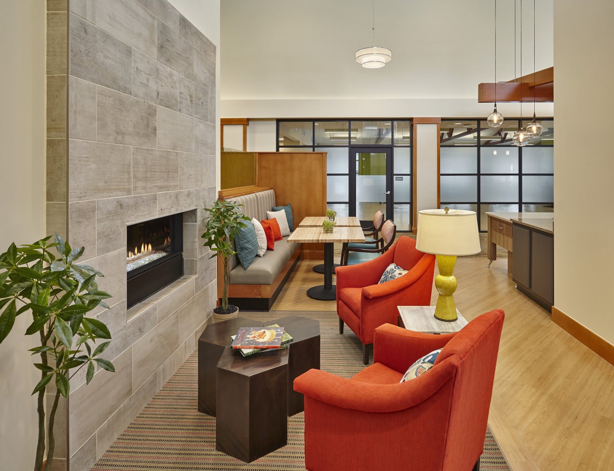 A modern living room with comfortable seating, a fireplace, and stylish decor.