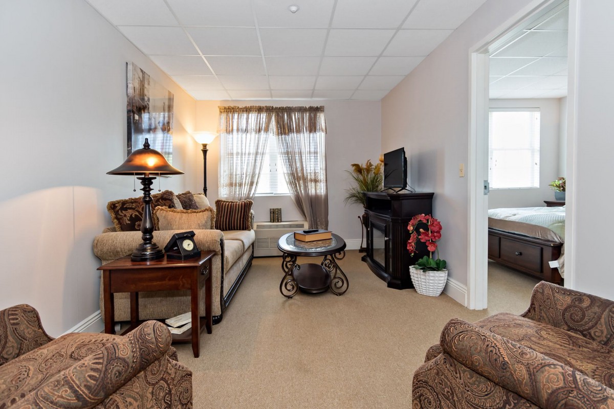 A cozy living room with comfortable seating and warm lighting.