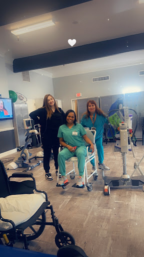 Healthcare professionals working together to support patient recovery in a rehabilitation setting.