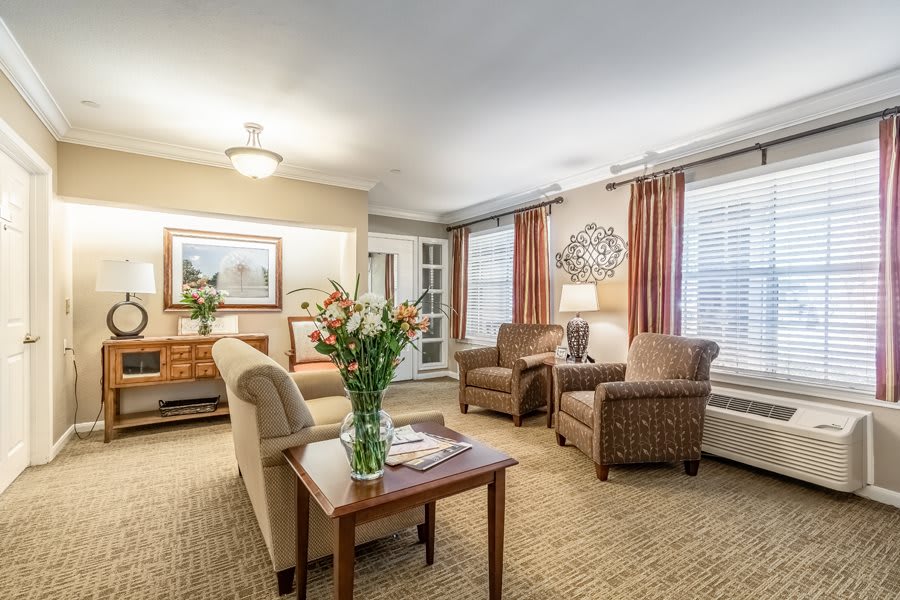 A cozy living room with comfortable seating and warm lighting.