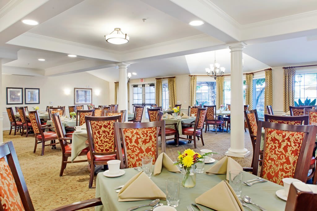 Elegant dining room with neatly arranged tables and chairs.