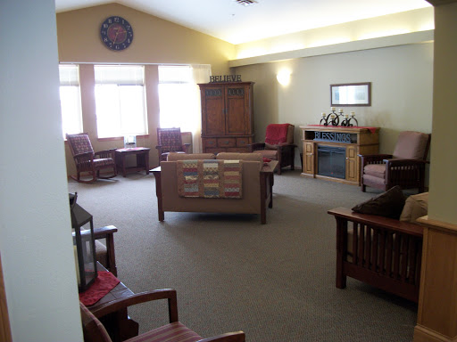 A cozy lounge area with comfortable seating and ample natural light.