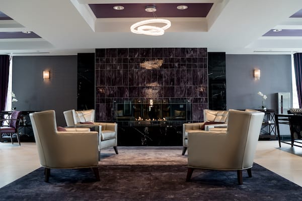 A modern seating area featuring armchairs and a stylish fireplace.