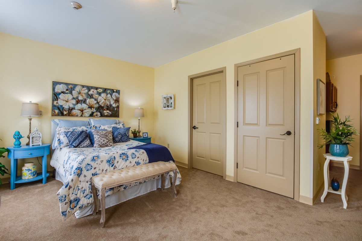 A cozy bedroom with floral decor and soft lighting.