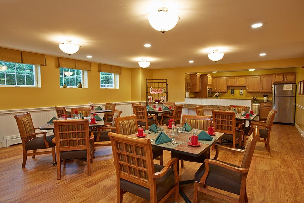 A cozy dining room setup with neatly arranged tables and chairs.