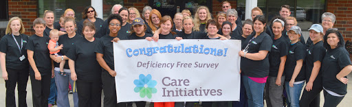 A happy team celebrates their achievement of a deficiency-free survey with Care Initiatives.