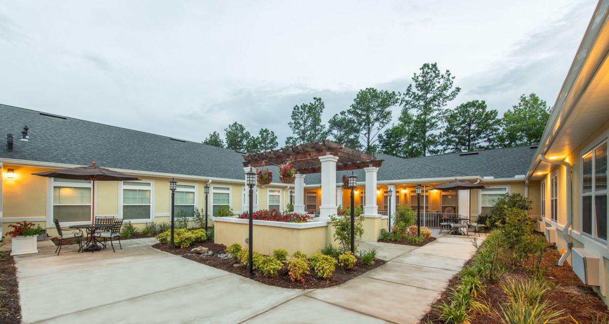 An inviting courtyard with well-maintained landscaping and a covered walkway.