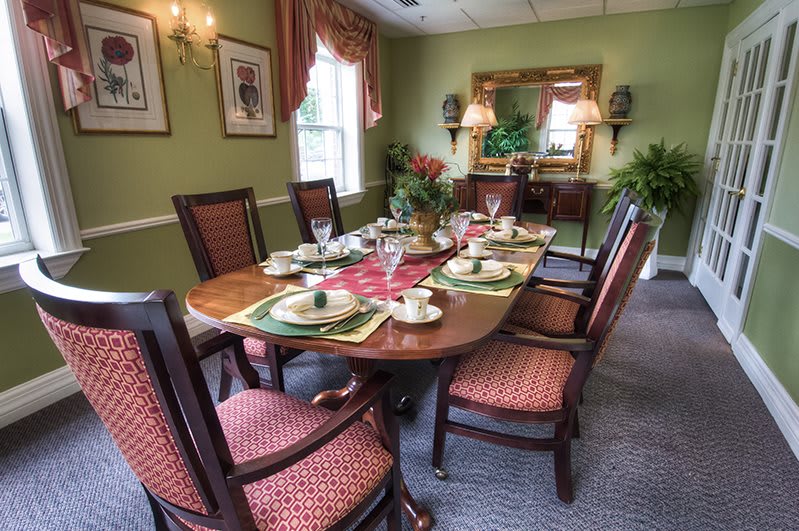 A traditional dining room with an elegantly set table.