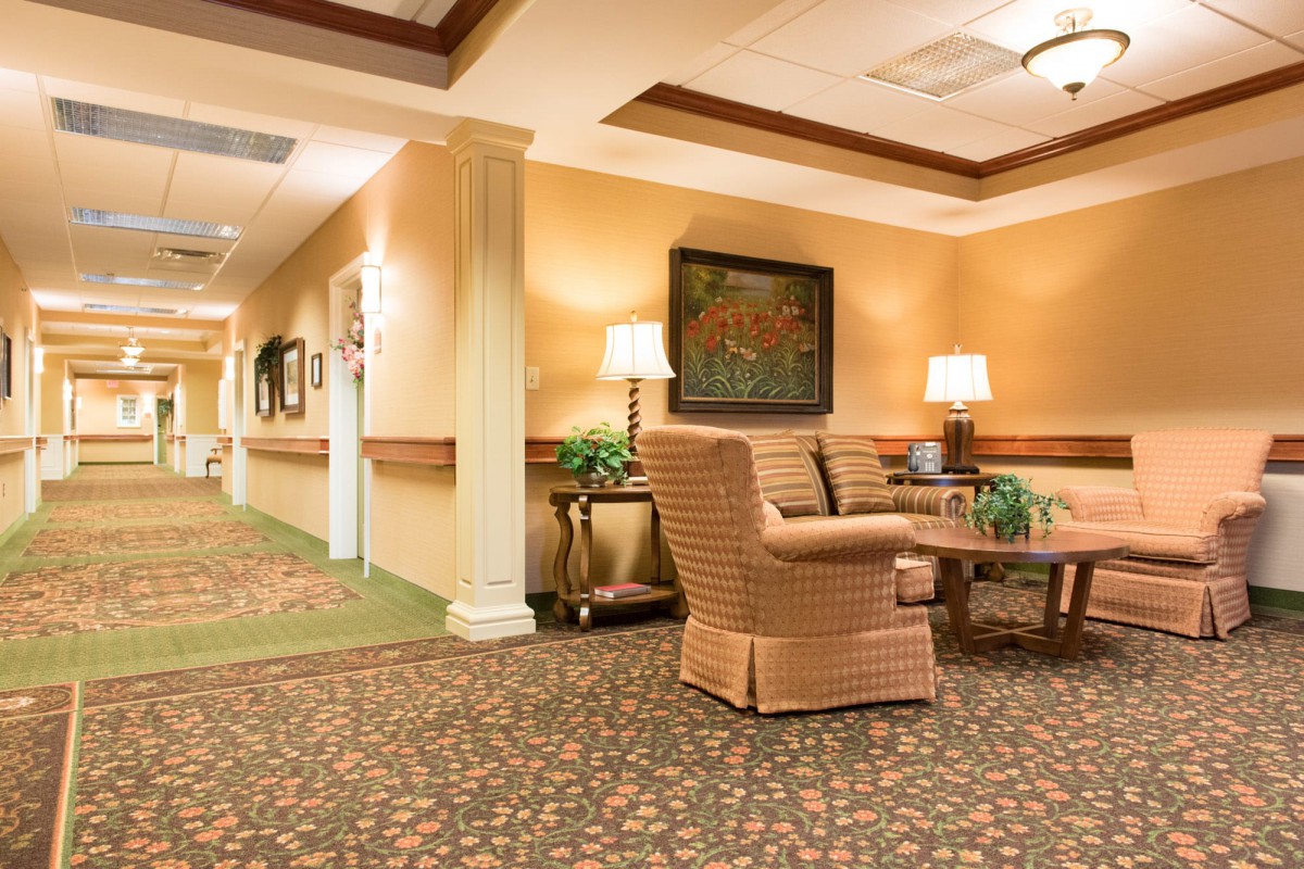 A warmly lit hallway with comfortable seating and elegant decor.