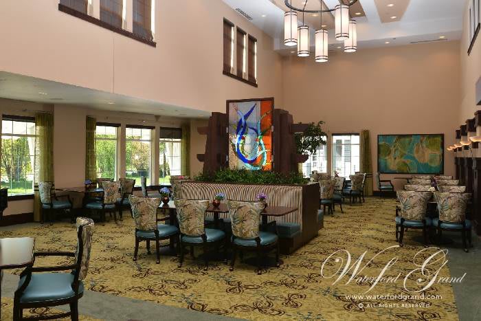 A modern dining area with stylish seating and elegant chandeliers.