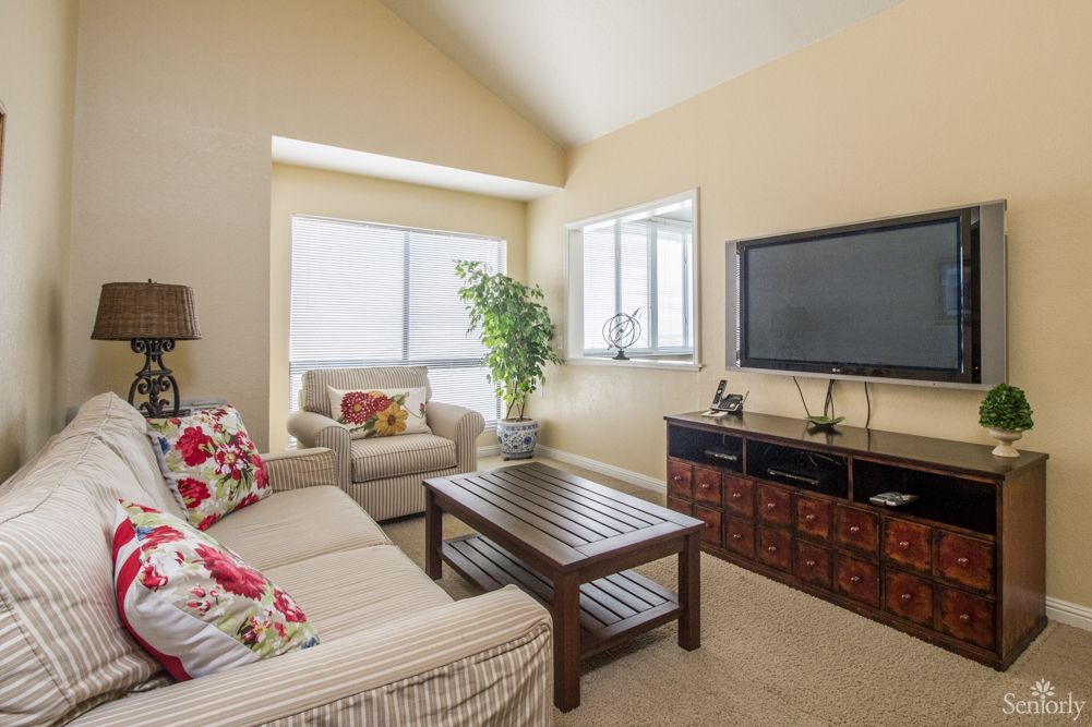 A cozy living room with comfortable seating and a television.