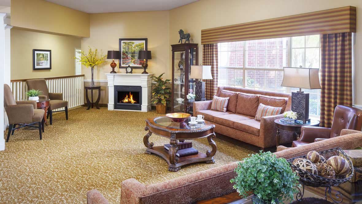 A cozy living room with a fireplace, comfortable seating, and elegant decor.