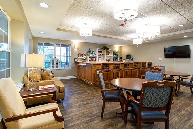A cozy interior featuring a combined living and dining area with comfortable seating and a small bar.