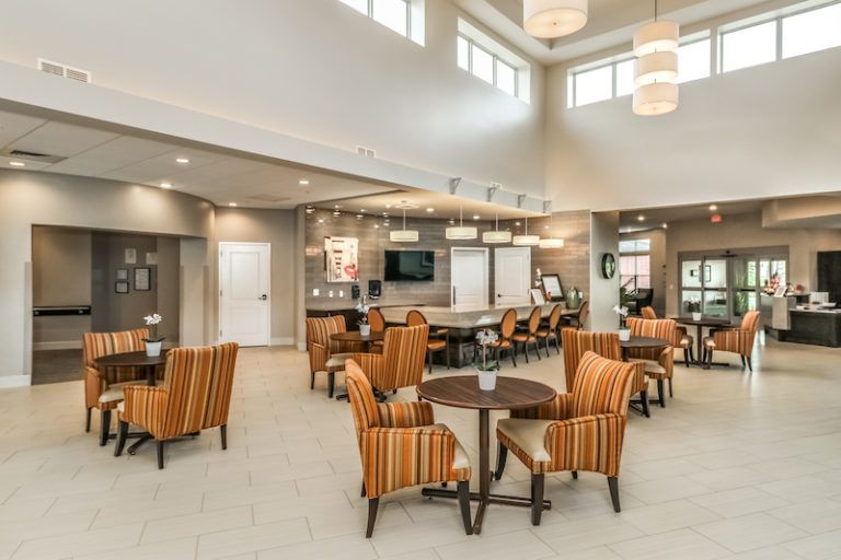 A modern lounge area with comfortable seating and bright lighting.